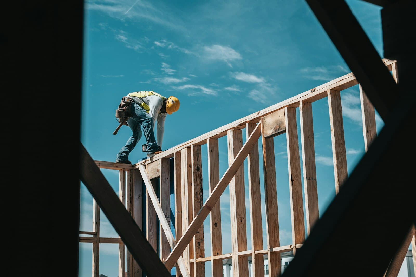 Construction worker framing a new building financed with a bridge loan