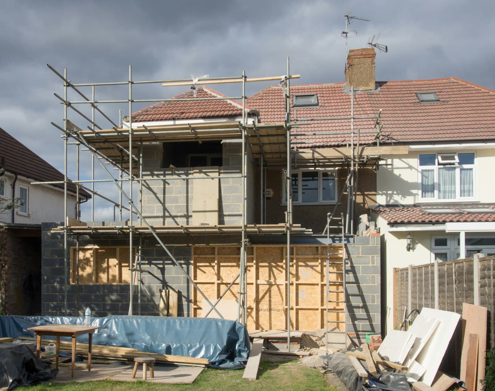 House under renovation with scaffolding, financed with a hard money loan