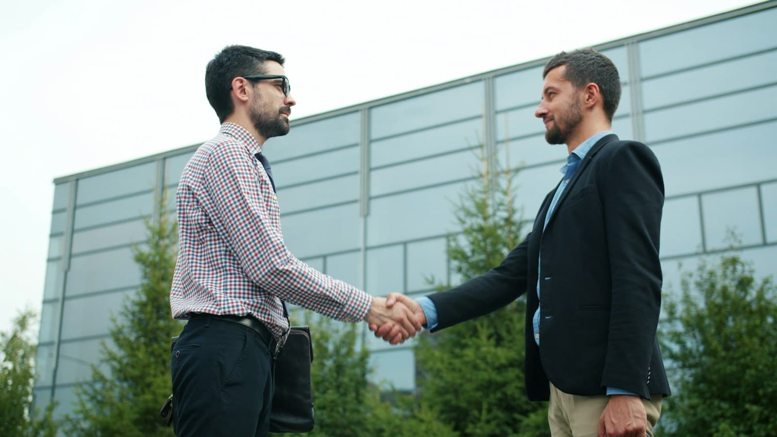 Investor meeting a private lender outside a modern building