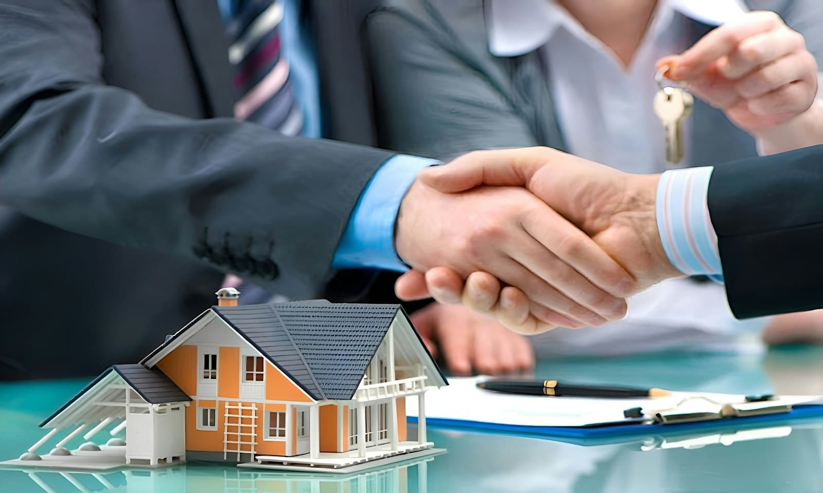 Real estate investor and private money lender shaking hands over a model house