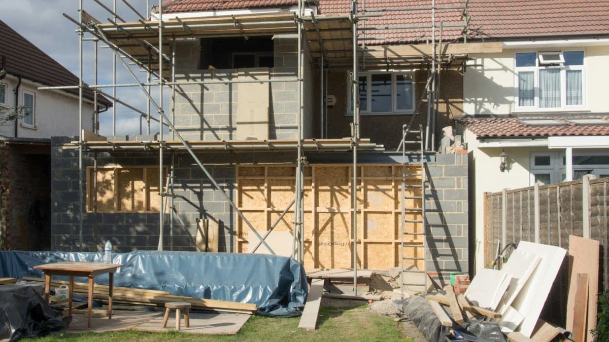 House under renovation with scaffolding, financed with a fix and flip loan